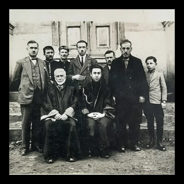 Close-up of the group of courthouse staff, with two robed people seated