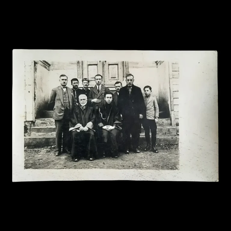 Photographic print dated 1930 of lawyers, prosecutors and court ushers in front of a building entrance