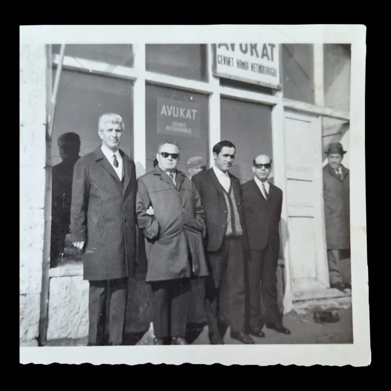 Close-up of the group in front of the office, with an 'Avukat' (lawyer) sign in the window