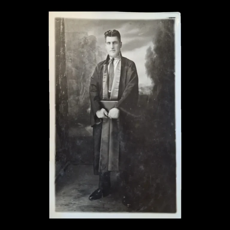 Standing portrait of a robed lawyer in front of a studio backdrop