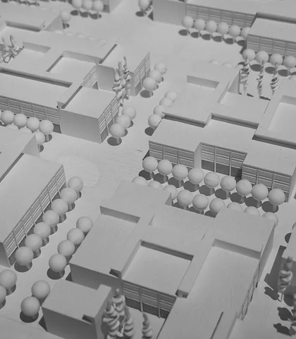 White and gray urban planning model with city blocks and trees
