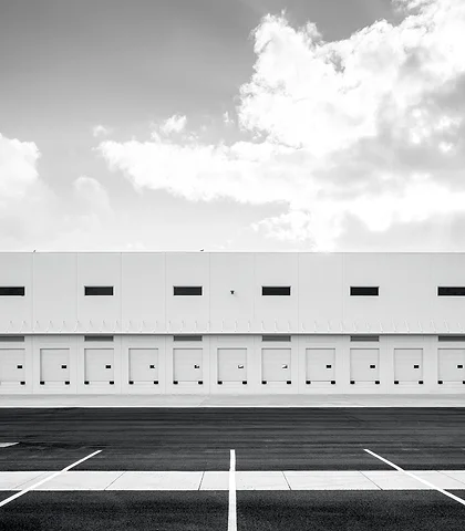 Modern warehouse facade with loading docks, black and white